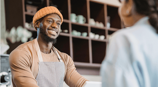 Local business - friendly business owner serving customer